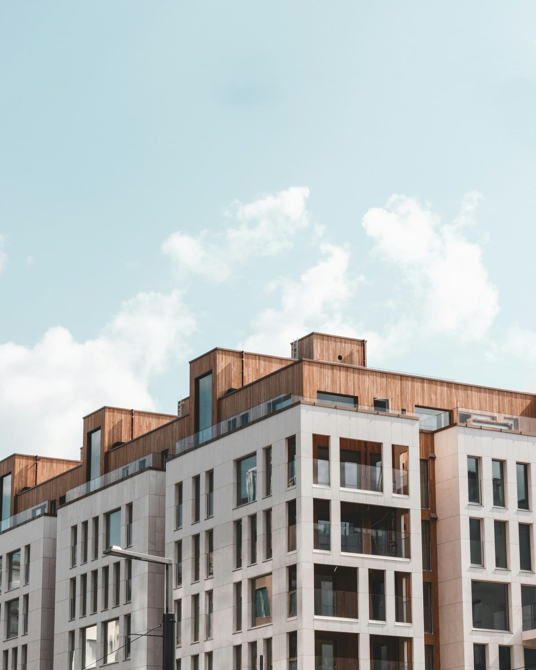 Demo image. Cream mid-rise building with a brick upper storey.